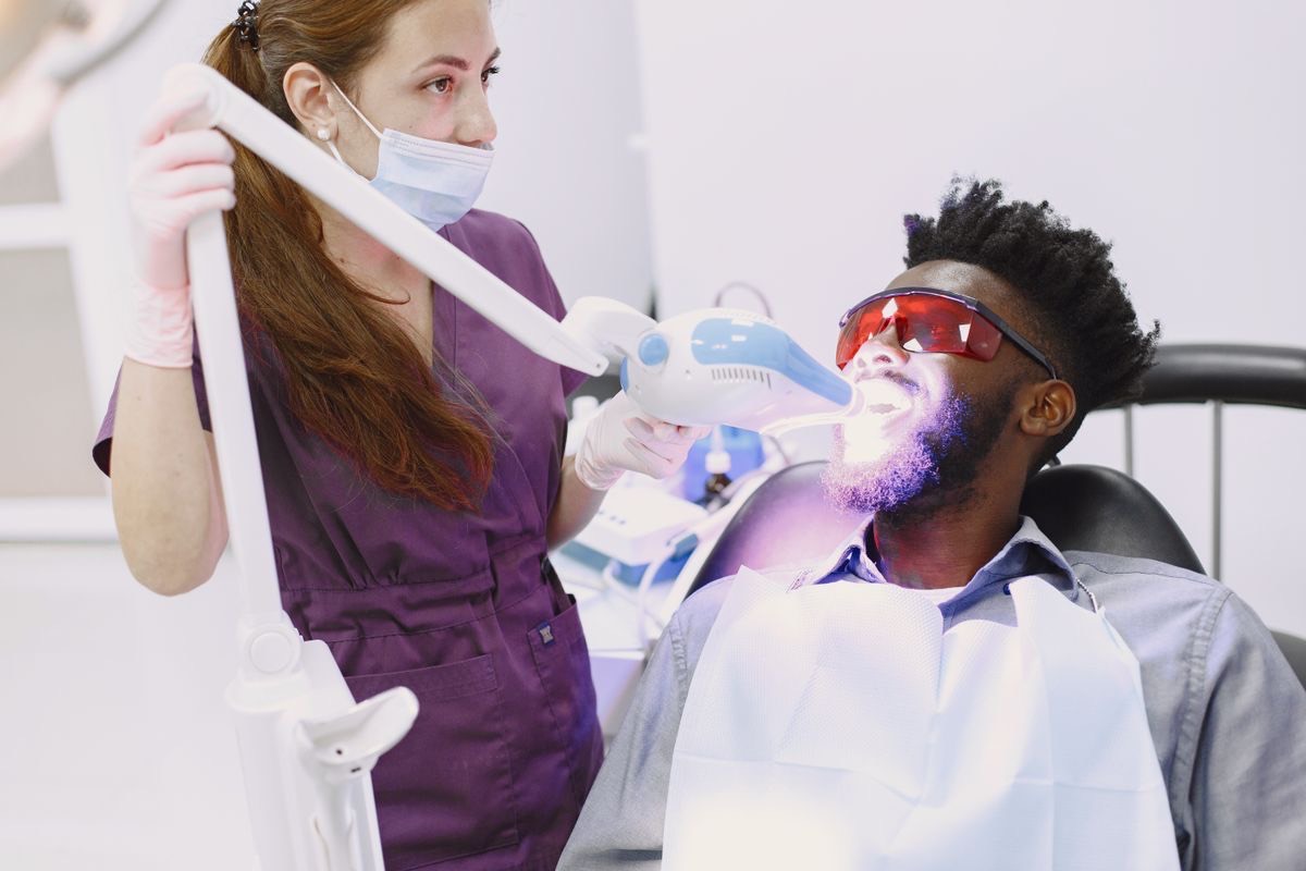 Dentist performing cosmetic teeth whitening for smile enhancement